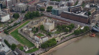 AX114_101E - 5.5K aerial stock footage tilt to bird's eye of tourists at the Tower of London, England