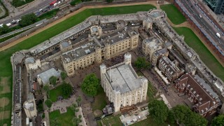 AX114_102 - 5.5K stock footage aerial video tilt to bird's eye of tourists at the Tower of London, England