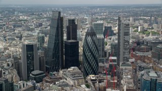 AX114_104 - 5.5K stock footage aerial video of orbiting The Gherkin and skyscrapers in Central London, England