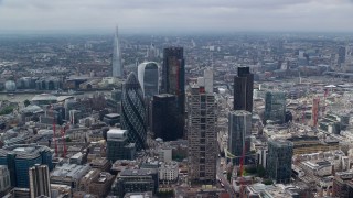 AX114_109E - 5.5K aerial stock footage of an orbit of skyscrapers in Central London, England, and The Shard in the background