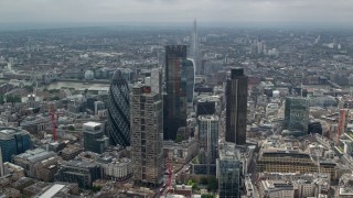 AX114_110 - 5.5K aerial stock footage of an orbit of skyscrapers in Central London, England, and The Shard in the background