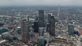 AX114_111 - 5.5K aerial stock footage of circling the skyscrapers in Central London, England, The Shard in the background