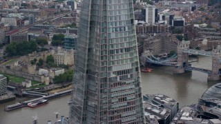 AX114_118 - 5.5K aerial stock footage of Tower of London and Tower Bridge on the River Thames, England, reveal The Shard