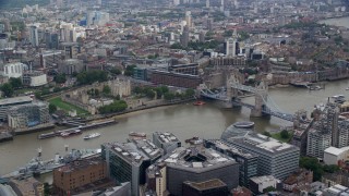 AX114_119E - 5.5K aerial stock footage of passing the Tower of London and Tower Bridge over the River Thames, England
