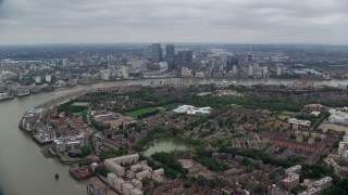 AX114_126E - 5.5K aerial stock footage of Canary Wharf skyscrapers on the opposite side of the River Thames, London, England