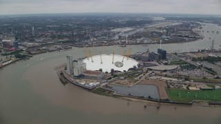 AX114_135E - 5.5K aerial stock footage of an orbit around the O2 Arena by the River Thames, London, England