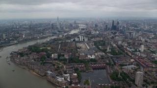 AX114_156E - 5.5K aerial stock footage approach The Shard and Central London skyscrapers by River Thames, England
