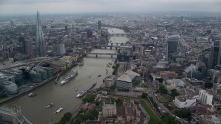 AX114_160E - 5.5K aerial stock footage of flying over London Bridge toward other bridges over the River Thames, England
