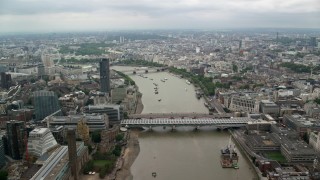 AX114_163 - 5.5K stock footage aerial video approach bridges while flying over River Thames, London, England