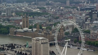 AX114_164 - 5.5K stock footage aerial video of the London Eye ferris wheel, Big Ben and Parliament, England
