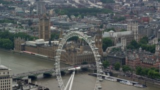 AX114_165 - 5.5K stock footage aerial video flyby London Eye to focus on Big Ben and Parliament, England
