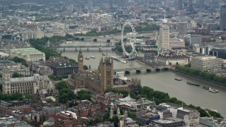 AX114_175 - 5.5K aerial stock footage of Big Ben, Parliament, and London Eye beside the River Thames, England