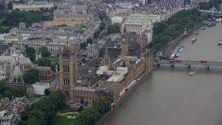 AX114_177E - 5.5K aerial stock footage of Big Ben, Parliament and Westminster Abbey across River Thames, London, England