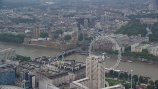 AX114_183E - 5.5K aerial stock footage of London Eye with Big Ben and British Parliament in the background, England