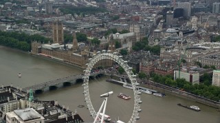 AX114_185 - 5.5K stock footage aerial video of approach Big Ben and Parliament from the London Eye, England