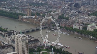AX114_185E - 5.5K aerial stock footage fly over London Eye toward Big Ben and Parliament, England