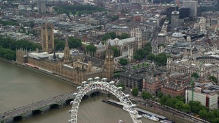 AX114_186 - 5.5K stock footage aerial video fly over London Eye toward Big Ben and Parliament, England
