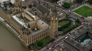 AX114_188 - 5.5K stock footage aerial video tilt to Big Ben and Parliament during approach from river, London, England
