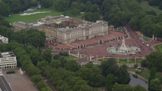 AX114_190E - 5.5K aerial stock footage of flying by Buckingham Palace and Victoria Memorial, London, England