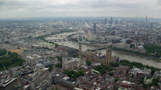 AX114_195 - 5.5K stock footage aerial video of Big Ben, Parliament and Westminster Abbey among city sprawl, London, England