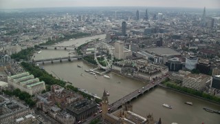 AX114_197 - 5.5K stock footage aerial video fly over Big Ben and Westminster Bridge toward London Eye, England