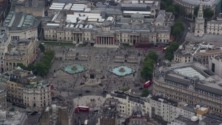 AX114_199E - 5.5K aerial stock footage of orbiting Trafalgar Square, London, England