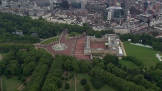 AX114_211E - 5.5K aerial stock footage orbit Buckingham Palace with wide view of the city, London, England