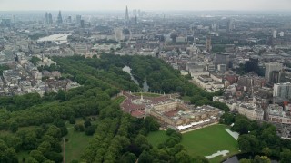 AX114_213 - 5.5K stock footage aerial video orbit Buckingham Palace with wide view of the city, London, England