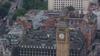 AX114_220E - 5.5K aerial stock footage of famous Big Ben and the British Flag, London, England