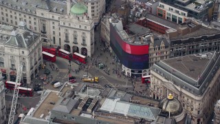 AX114_241 - 5.5K aerial stock footage of an orbit around buses and traffic at Piccadilly Circus, London, England