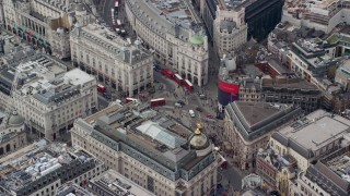 AX114_242E - 5.5K aerial stock footage of Piccadilly Circus with tourists and buses, London, England