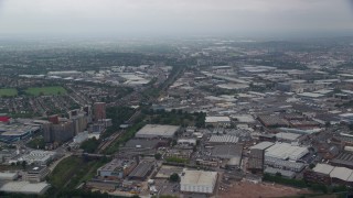 AX114_272E - 5.5K aerial stock footage fly over warehouses and train tracks near the A40 highway, London, England