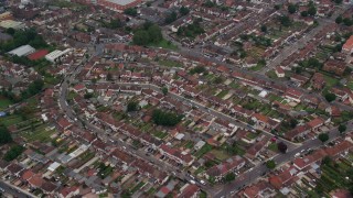 AX114_282 - 5.5K aerial stock footage tilt to homes while flying over residential neighborhood in Southall, England
