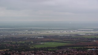 AX114_284E - 5.5K aerial stock footage of flying by London Heathrow Airport, England