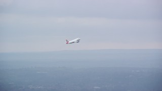 AX114_292 - 5.5K aerial stock footage tracking commercial jet while ascending from Heathrow Airport, England