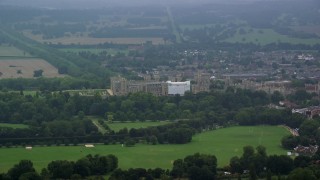 AX114_303 - 5.5K aerial stock footage of a view of Windsor Castle and green trees, England