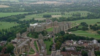AX114_314 - 5.5K stock footage aerial video of passing by Windsor Castle and St George's Chapel, England