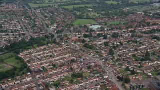 AX114_320E - 5.5K aerial stock footage of orbiting a residential neighborhood and fly away, Slough, England