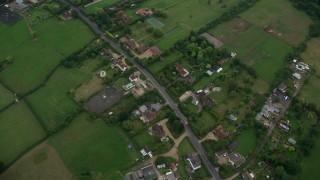 AX114_332 - 5.5K aerial stock footage tilt to bird's eye view of farm fields and rural homes, Windsor, England