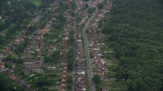 AX114_339 - 5.5K aerial stock footage of residential neighborhoods among trees, Ascot, England
