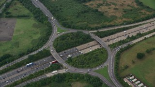 AX114_354 - 5.5K aerial stock footage of orbiting M25 Freeway roundabout, Chertsey, England