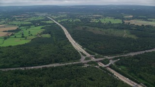 AX114_359E - 5.5K aerial stock footage following the M25 Freeway past farmland and forests, Cobham, England