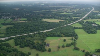 AX114_374E - 5.5K aerial stock footage of village homes and trees near Walton Heath Golf Club in Tadworth, England