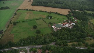 AX115_001E - 5.5K aerial stock footage fly over homes and farmland, Redhill, England