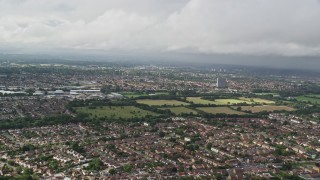 AX115_012E - 5.5K aerial stock footage approach residential neighborhoods, Chessington, England