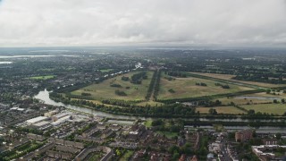 AX115_017E - 5.5K aerial stock footage approach Hampton Court Palace and Park from residential neighborhoods, England