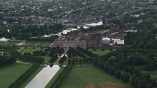 AX115_020E - 5.5K aerial stock footage of orbiting Hampton Court Palace, Molesey, England