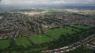 AX115_034E - 5.5K aerial stock footage fly over homes in residential neighborhoods, Surbiton, England
