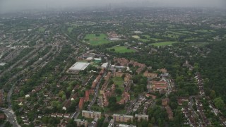 AX115_053 - 5.5K aerial stock footage of approaching Kingsdale School in rain, London, England