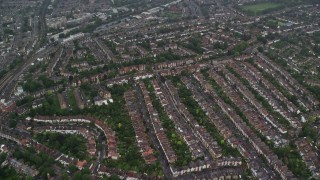 AX115_054E - 5.5K aerial stock footage of flying over residential neighborhoods in the rain, London, England